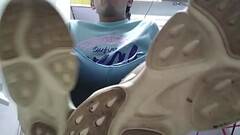 Dirty sneakers and red sweaty socks after walk Thumb