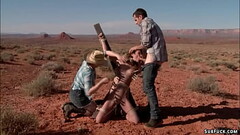 Deviant couple torment babe in desert Thumb